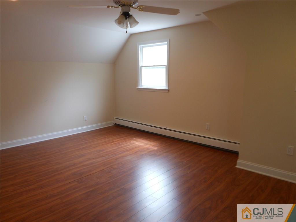 161 Jordan Road Colonia, NJ 07067 - Photo 12 of 15 an empty room with wooden floor and windows