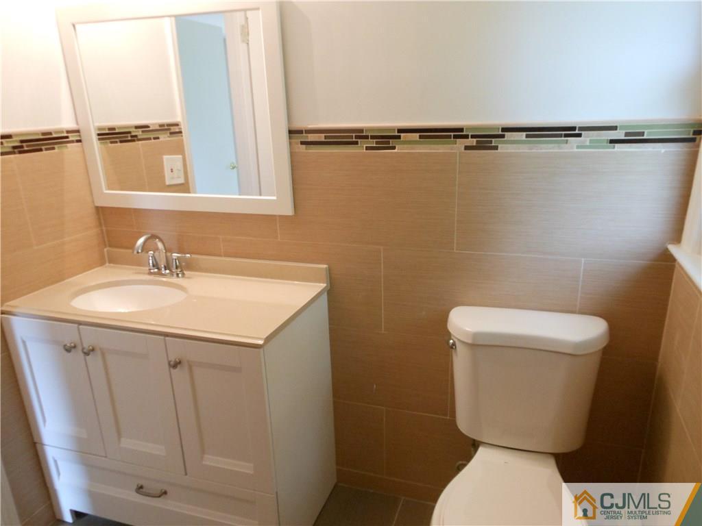 161 Jordan Road Colonia, NJ 07067 - Photo 15 of 15 a bathroom with a sink a toilet and a mirror