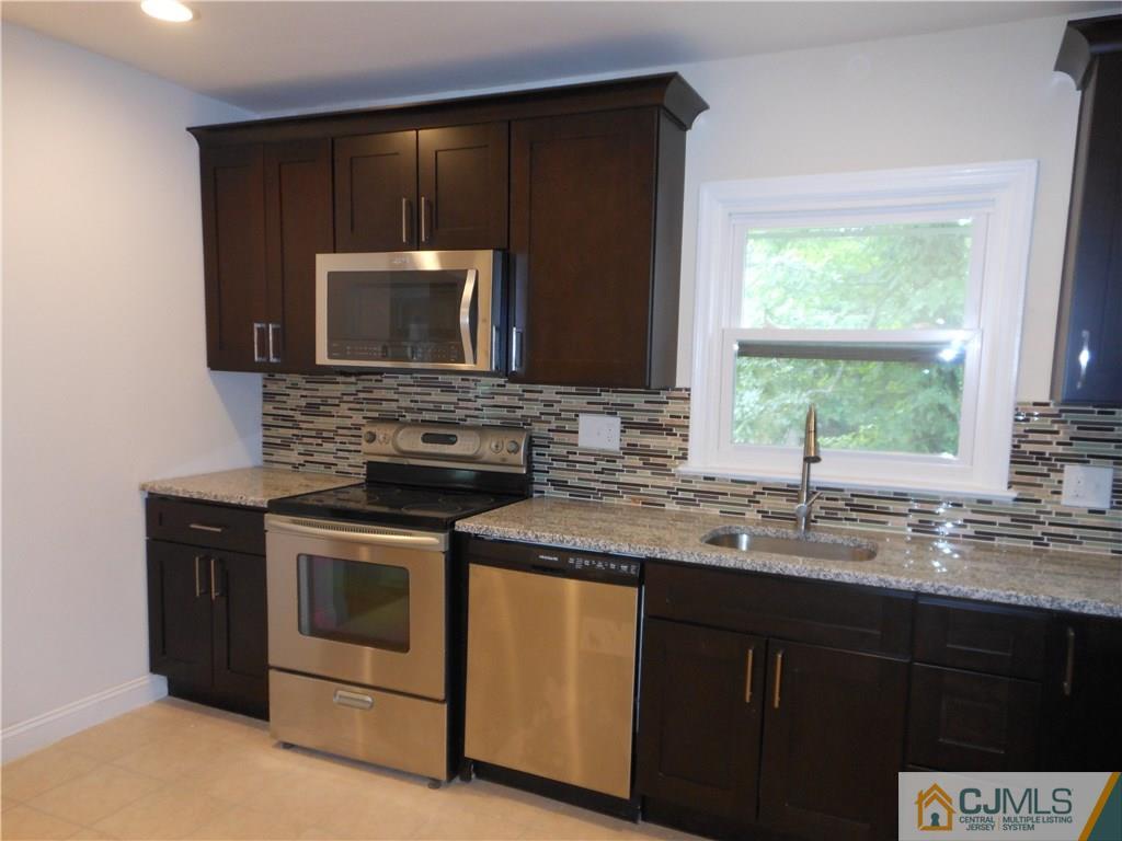 161 Jordan Road Colonia, NJ 07067 - Photo 5 of 15 a kitchen with stainless steel appliances granite countertop a stove a sink and a microwave