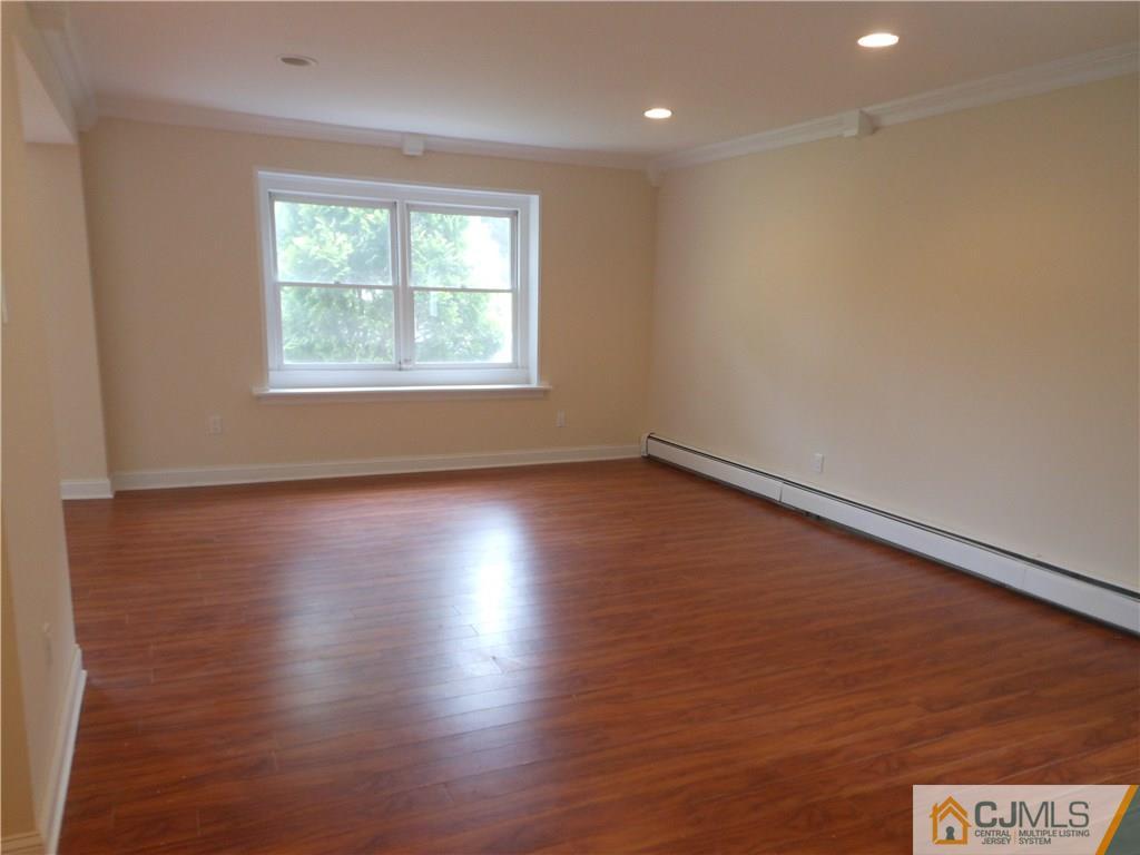 161 Jordan Road Colonia, NJ 07067 - Photo 6 of 15 an empty room with wooden floor and windows