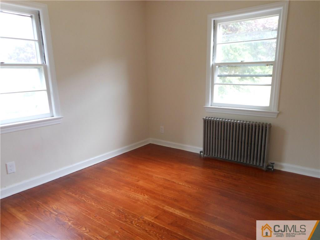 161 Jordan Road Colonia, NJ 07067 - Photo 9 of 15 an empty room with wooden floor and windows