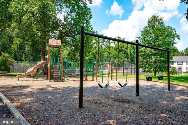 a sign of golf club on a wall under a tree