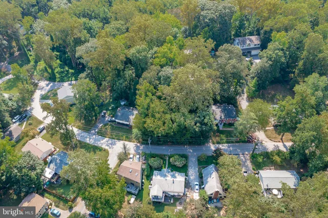 an aerial view of a house with a yard basket ball court and outdoor seating