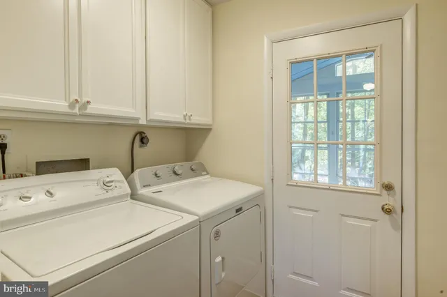 a view of a hallway with a chandelier fan