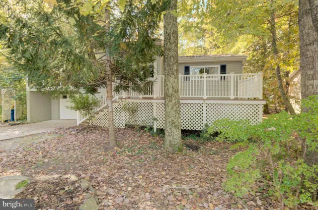 a view of a hallway with wooden floor and a chandelier