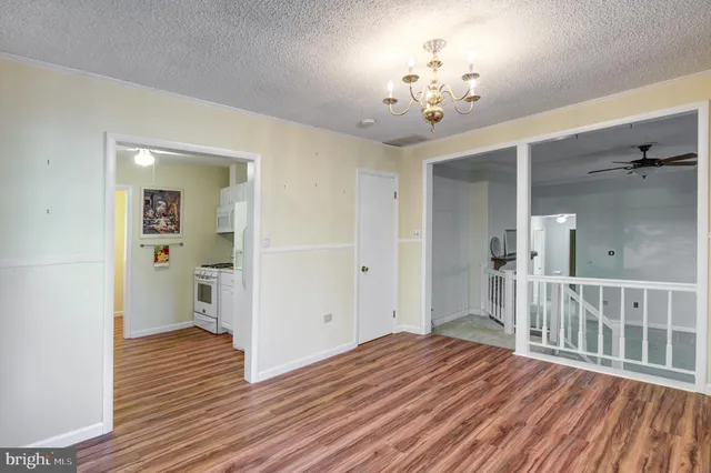 a kitchen with stainless steel appliances granite countertop a stove a refrigerator and a white cabinets