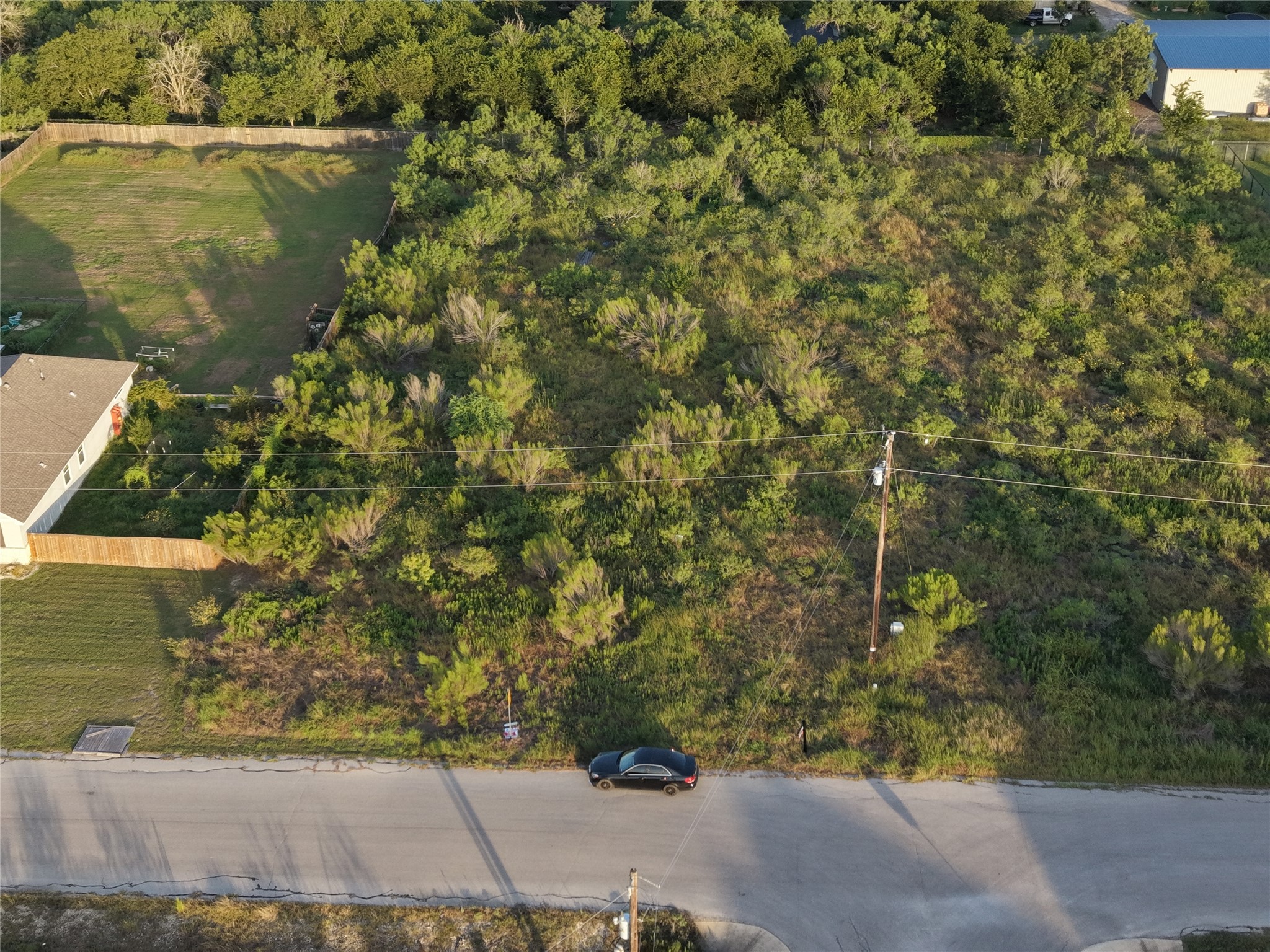 232 East Ridge Lane Kyle, TX 78640 - Photo 25 of 36 An aerial perspective reveals a substantial, tree-lined lot offering vast development potential.