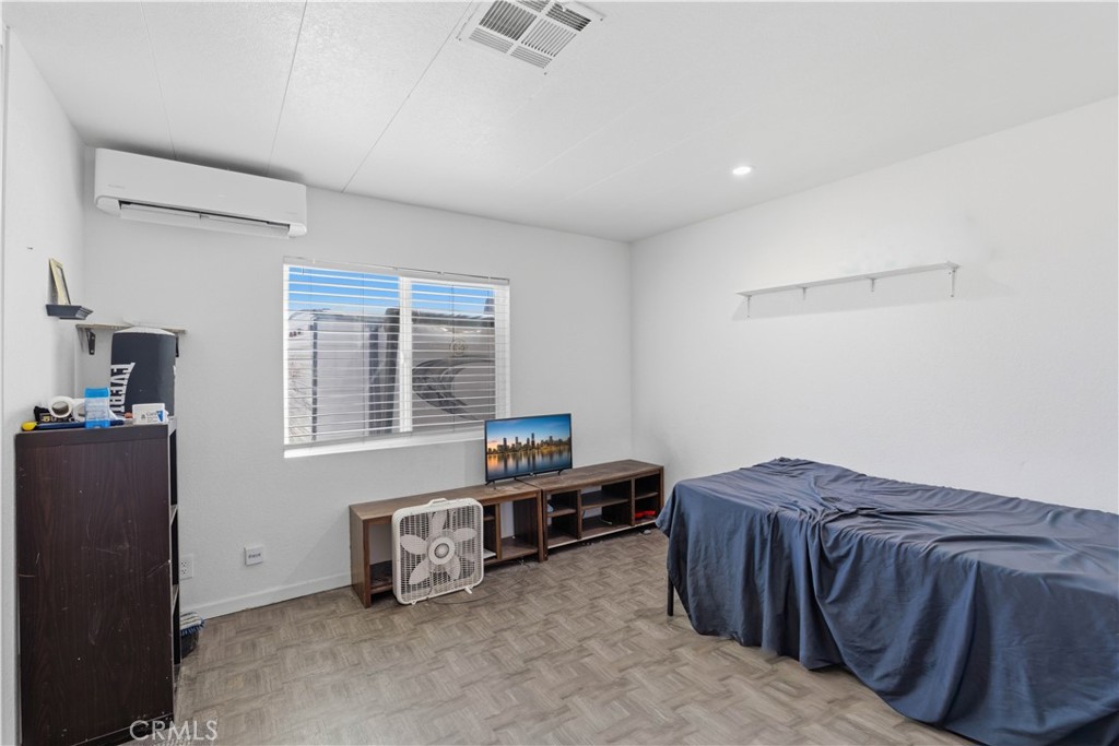 5885 Dos Palmas Road Phelan, CA 92371 - Photo 20 of 40 a bedroom with a bed and a window
