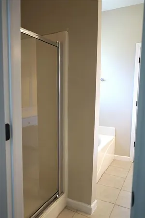 a bathroom with a granite countertop sink and a mirror a bathtub