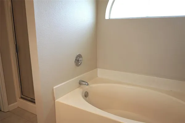 a white toilet sitting in a bathroom next to a window