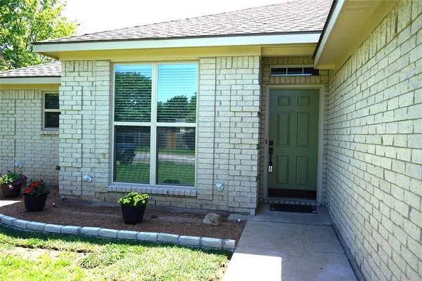 a front view of a house with a plants