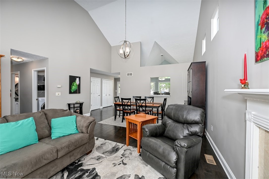 4902 Foote Road, Unit 33 Medina, OH 44256 - Photo 9 of 46 Living room featuring an inviting chandelier, hardwood / wood-style flooring, a premium fireplace, and high vaulted ceiling