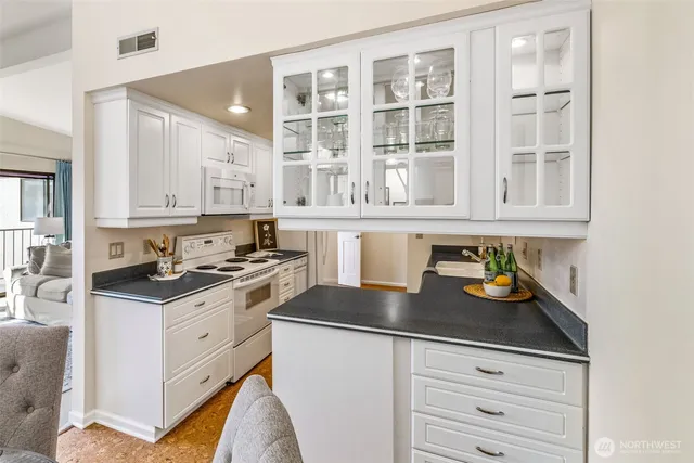 a kitchen with stainless steel appliances granite countertop a stove and cabinets