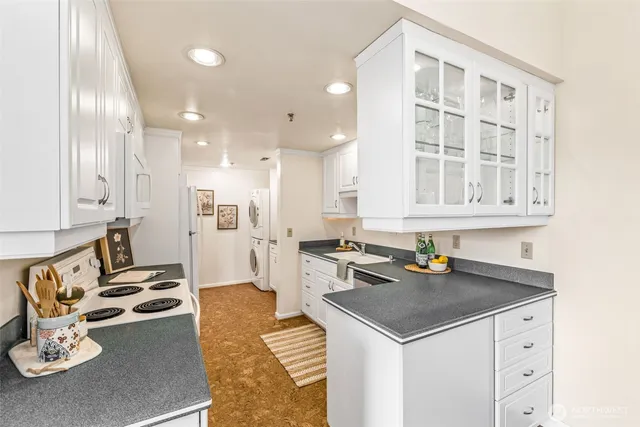 a kitchen with a sink a stove and chairs