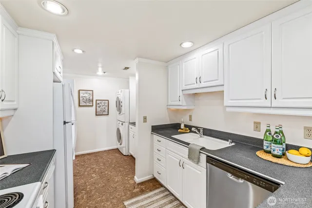 a kitchen with stainless steel appliances granite countertop a refrigerator and a stove top oven