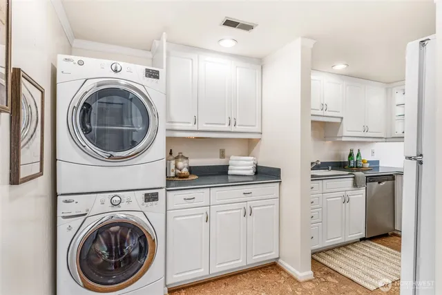 a kitchen with stainless steel appliances white cabinets and a sink