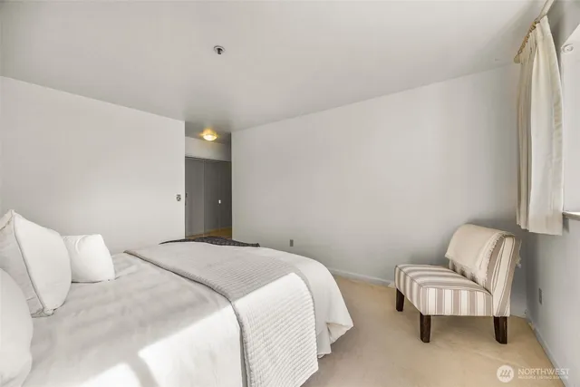 a bedroom with a bed and a couch