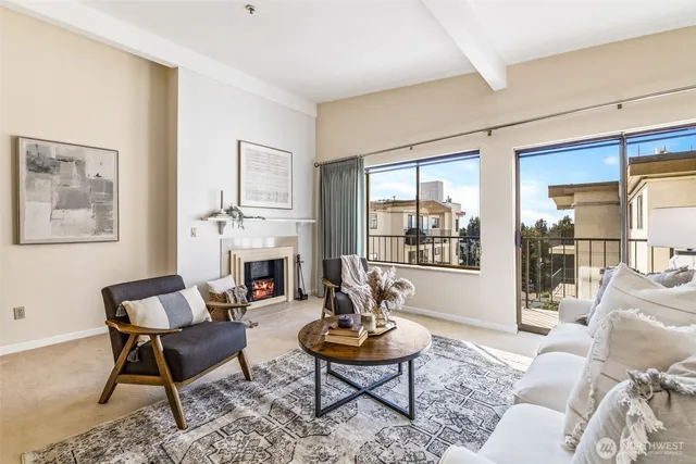 a living room with furniture a fireplace and a table