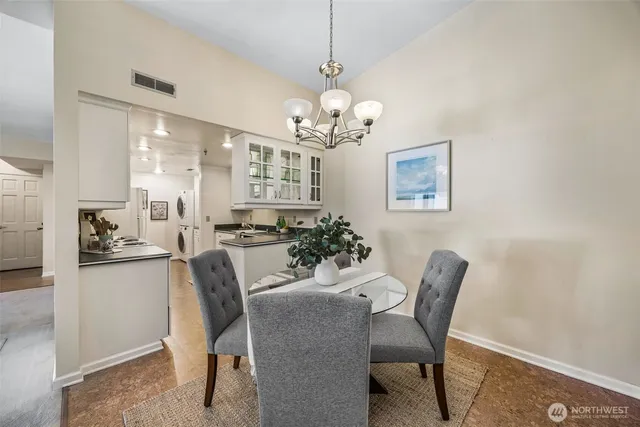 a view of a dining room with furniture a chandelier and wooden floor