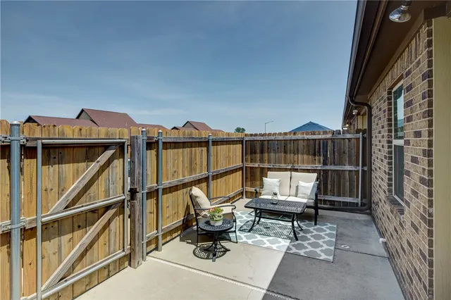 a view of a roof deck with wooden floor and a potted plant