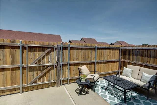 a view of a terrace with couches and wooden floor