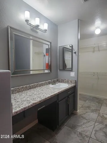 a bathroom with a sink and a mirror