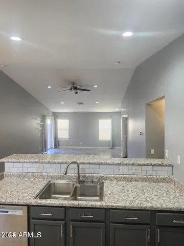a bathroom with a granite countertop sink a large mirror and vanity