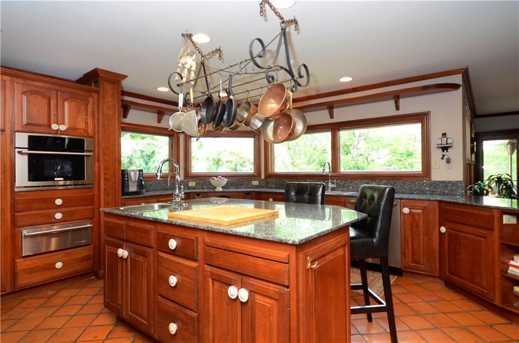 181 Merriman Road Sewickley Heights, PA 15143 - Photo 11 of 25 Kitchen with center island, cherry cabinetry, granite countertops and sink.