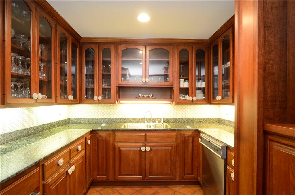 181 Merriman Road Sewickley Heights, PA 15143 - Photo 13 of 25 Efficient butler's pantry with cherry cabinetry & granite countertops located between dining room and kitchen.