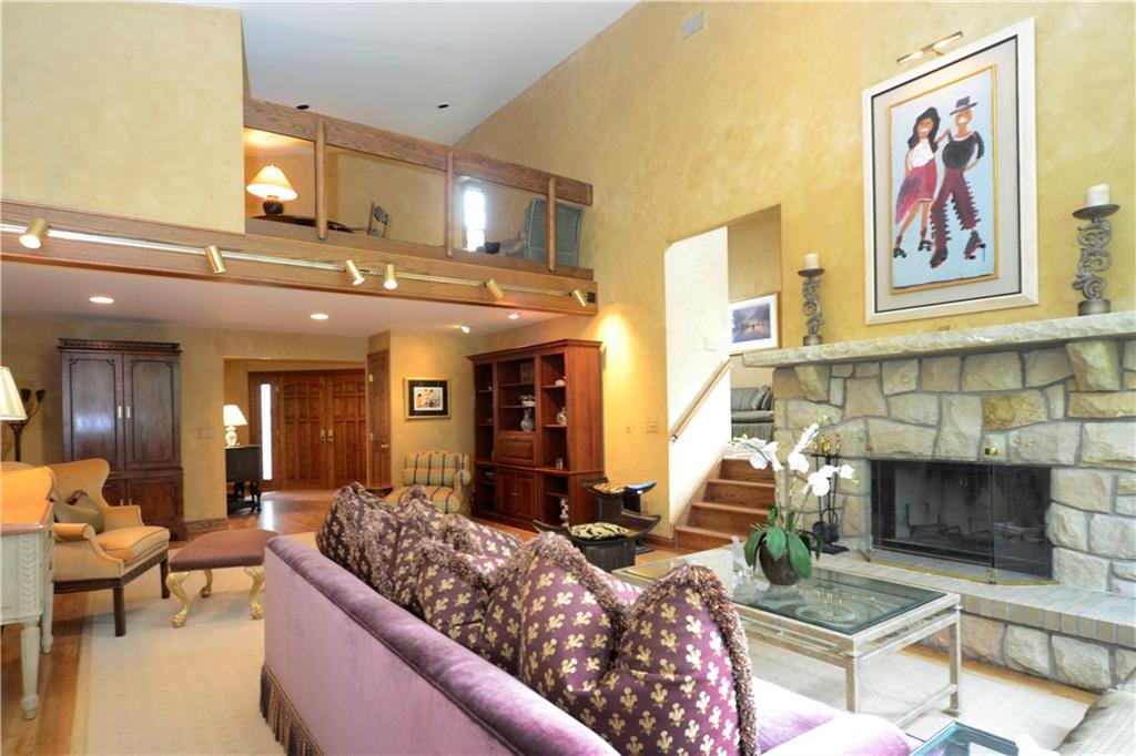 181 Merriman Road Sewickley Heights, PA 15143 - Photo 6 of 25 Magnificent living room with stone fireplace and stairs to loft, sitting room and guest suite with full bath.