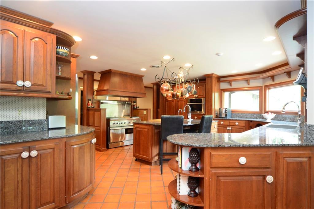 181 Merriman Road Sewickley Heights, PA 15143 - Photo 9 of 25 Gourmet kitchen with cherry cabinetry, tile flooring, granite countertops and top-of-the-line appliances.