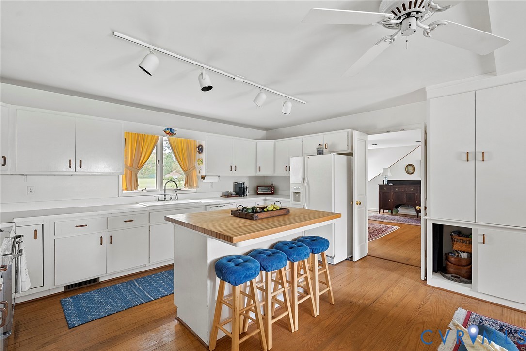 448 McSwain Road White Stone, VA 22578 - Photo 27 of 50 Kitchen with a breakfast bar, white cabinetry, tra