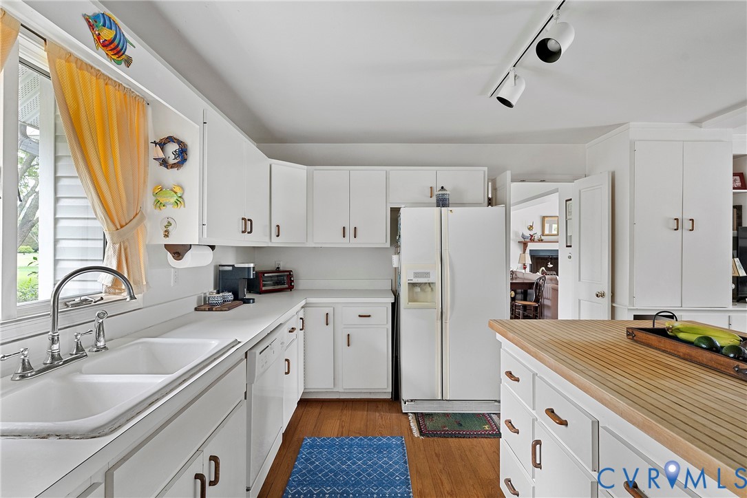 448 McSwain Road White Stone, VA 22578 - Photo 28 of 50 Kitchen with white cabinets, light wood finished f