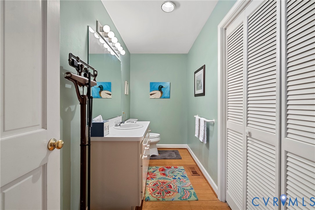448 McSwain Road White Stone, VA 22578 - Photo 35 of 50 Half bath featuring a closet, vanity, and light wo