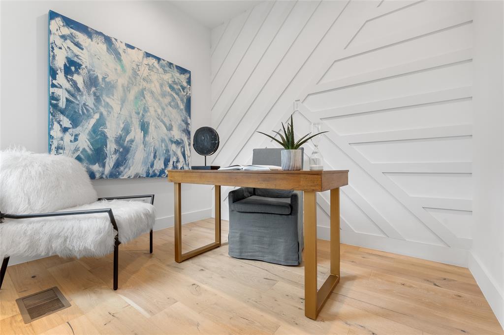 3915 North Hall Street, Unit 202 Dallas, TX 75219 - Photo 1 of 18 a bedroom with a bed and a table