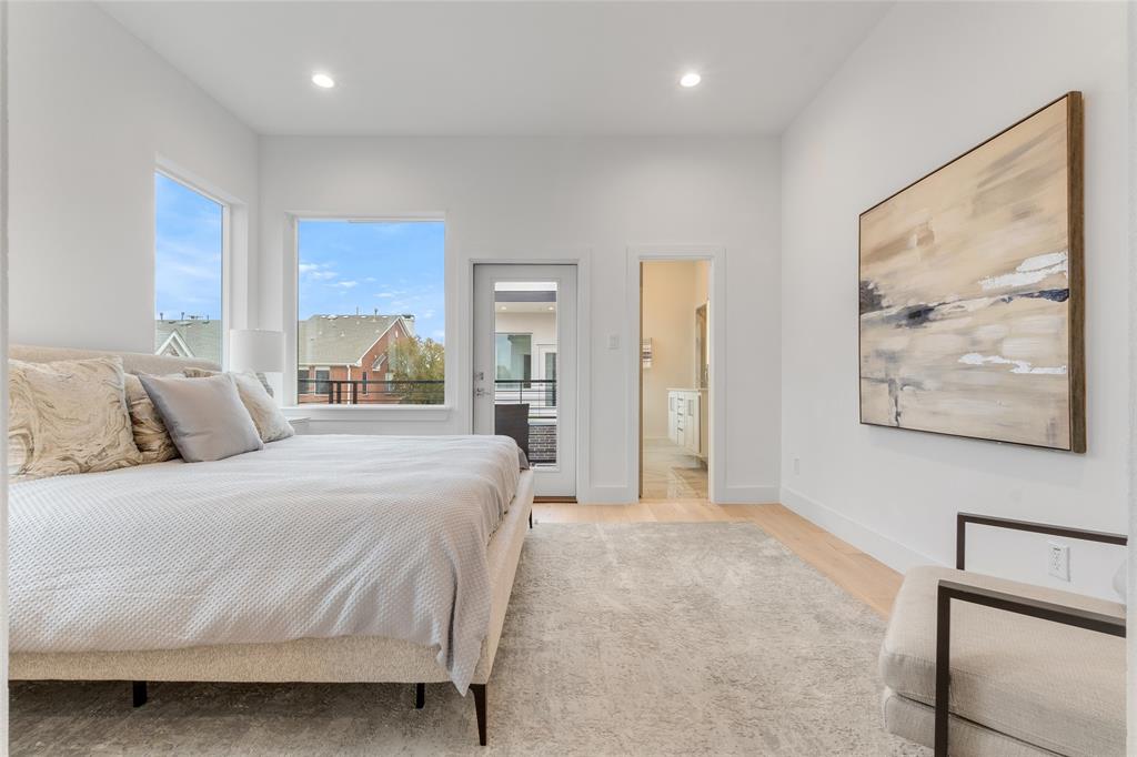 3915 North Hall Street, Unit 202 Dallas, TX 75219 - Photo 12 of 18 a bedroom with a bed and a painting on the wall