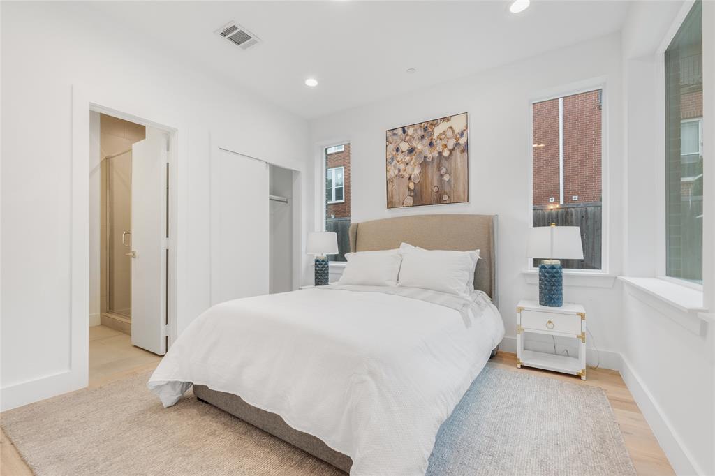 3915 North Hall Street, Unit 202 Dallas, TX 75219 - Photo 3 of 18 a spacious bedroom with a bed and a cabinets