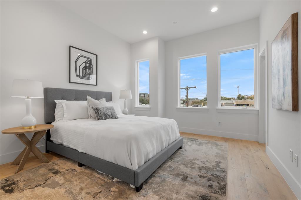 3915 North Hall Street, Unit 202 Dallas, TX 75219 - Photo 9 of 18 a spacious bedroom with a bed and window