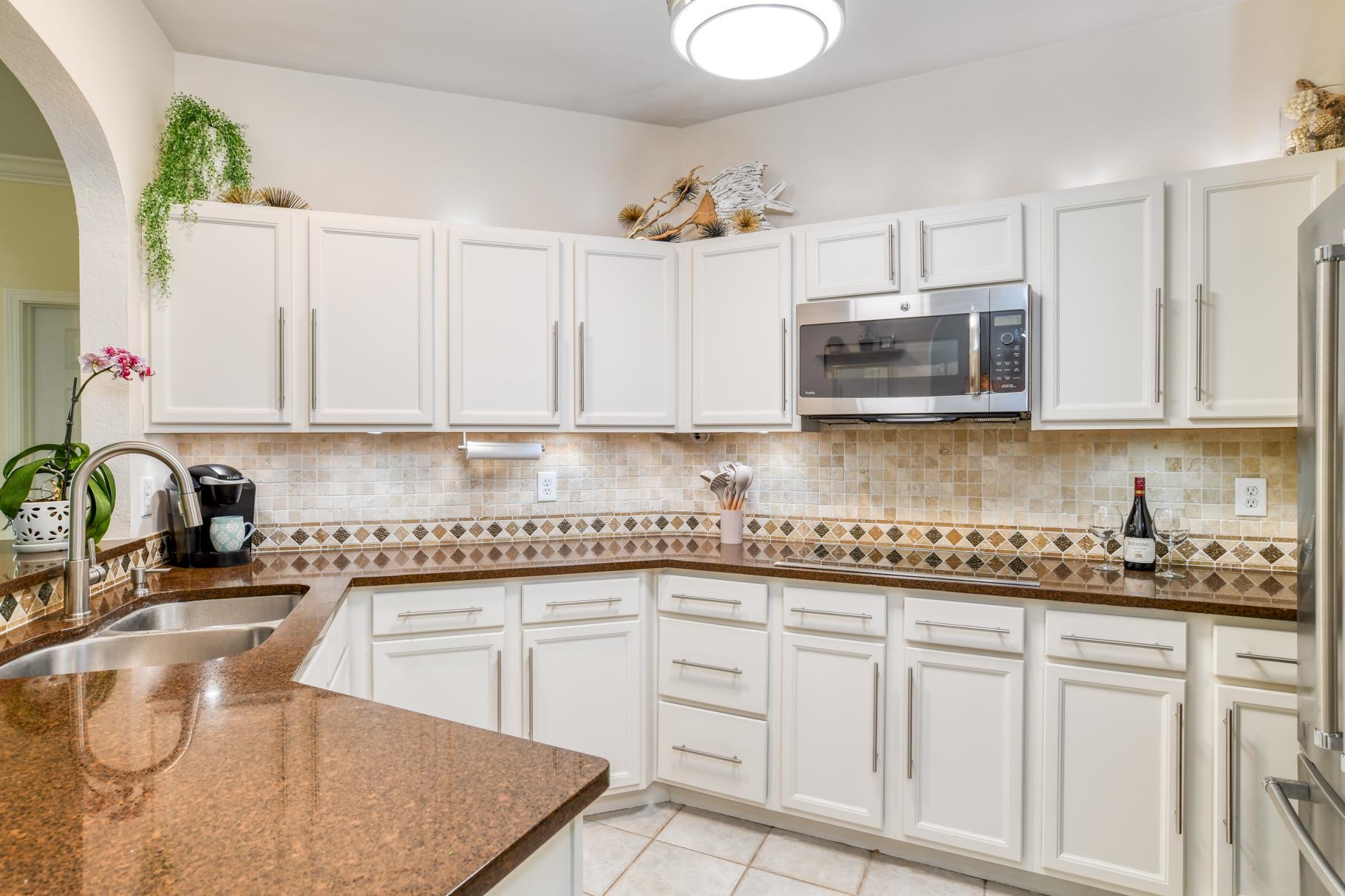 1825 Vista Cove Road St. Augustine, FL 32084 - Photo 18 of 66 a kitchen with stainless steel appliances granite countertop a sink stove and microwave