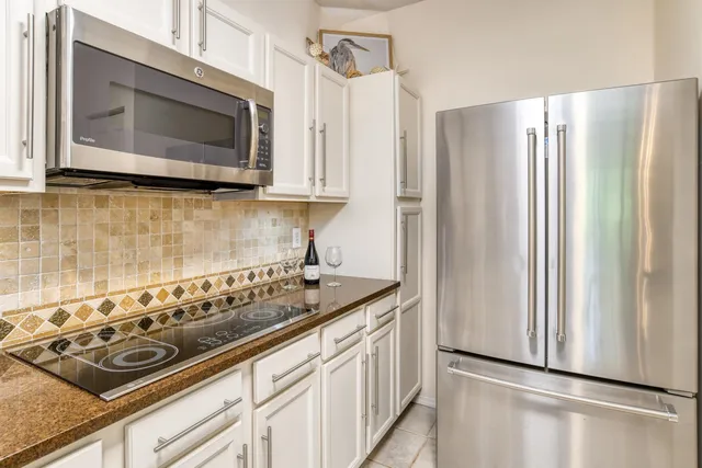 a bedroom with a bed window and a chandelier