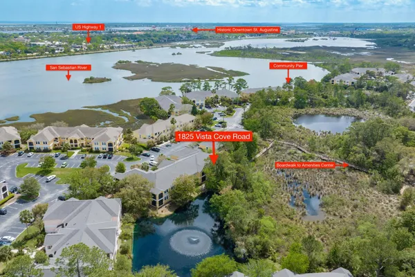 an aerial view of residential houses with outdoor space and street view