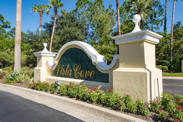 a view of a fountain in front of a house with a big yard