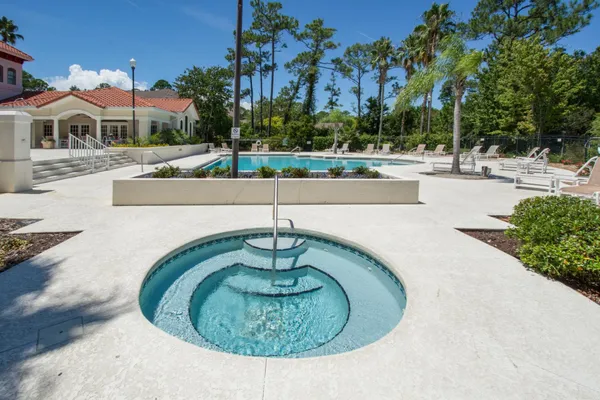 an aerial view of residential house with outdoor space and trees all around