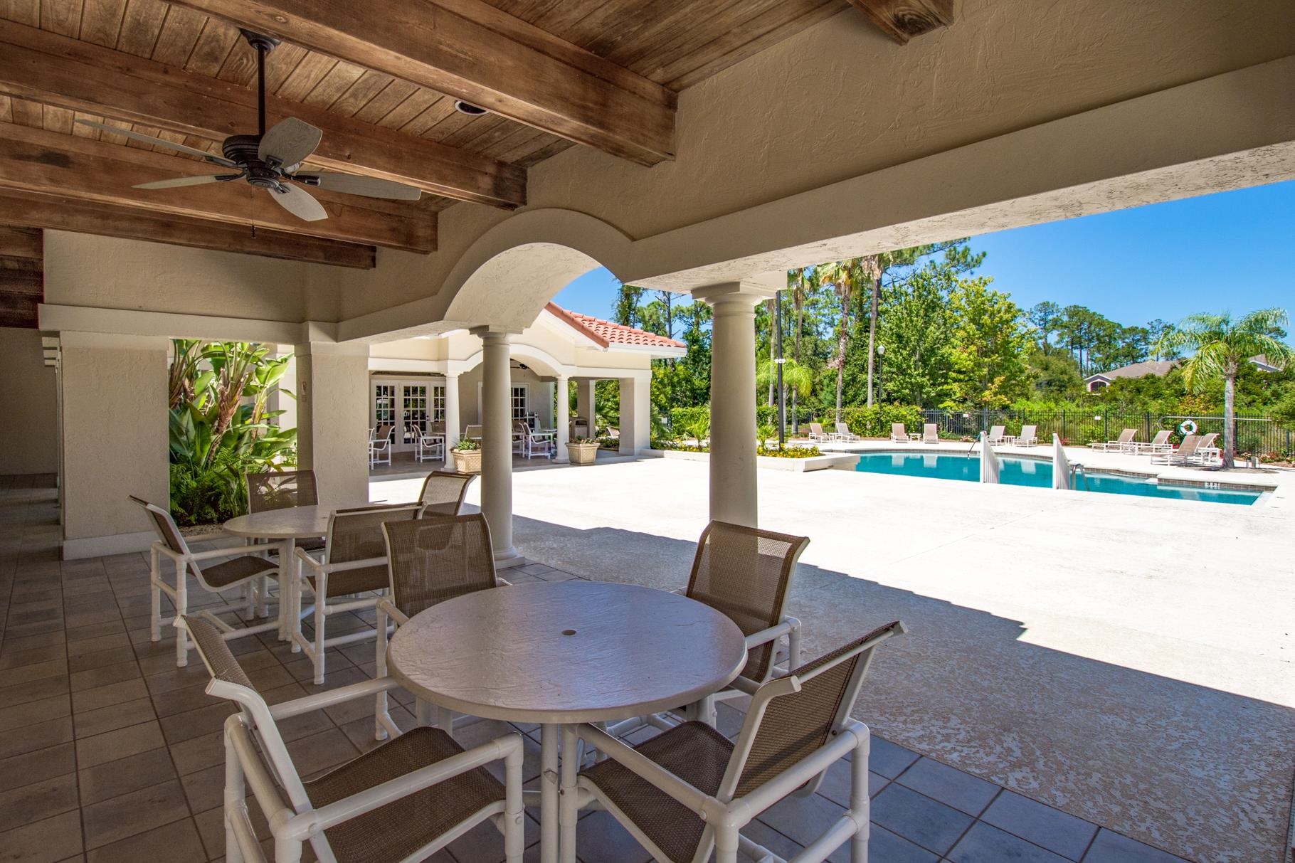 1825 Vista Cove Road St. Augustine, FL 32084 - Photo 43 of 66 a view of a patio with a table and chairs