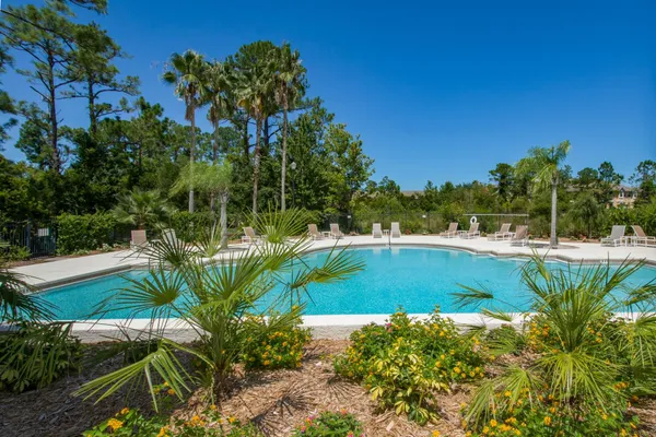a living room with furniture and a dining table with kitchen view