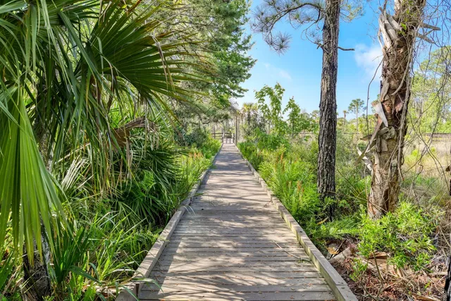 a living room with furniture a fireplace and a large window