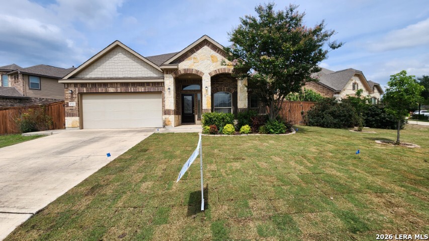 8722 Study Butte San Antonio, TX 78254 - Photo 1 of 40 a front view of a house with a yard and garage