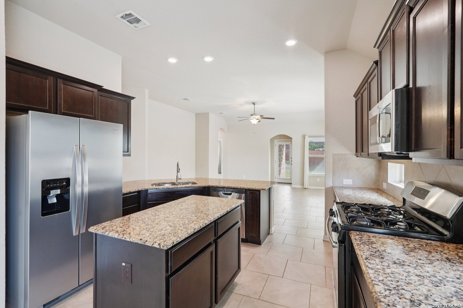 8722 Study Butte San Antonio, TX 78254 - Photo 12 of 40 a kitchen with stainless steel appliances granite countertop a sink stove and refrigerator