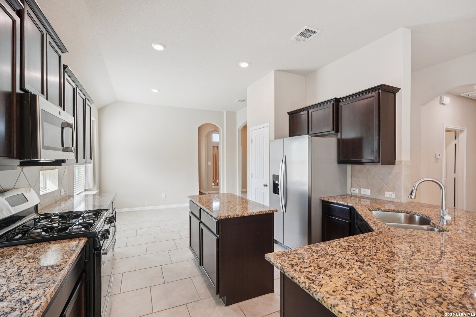 8722 Study Butte San Antonio, TX 78254 - Photo 13 of 40 a kitchen with stainless steel appliances granite countertop a refrigerator stove and sink