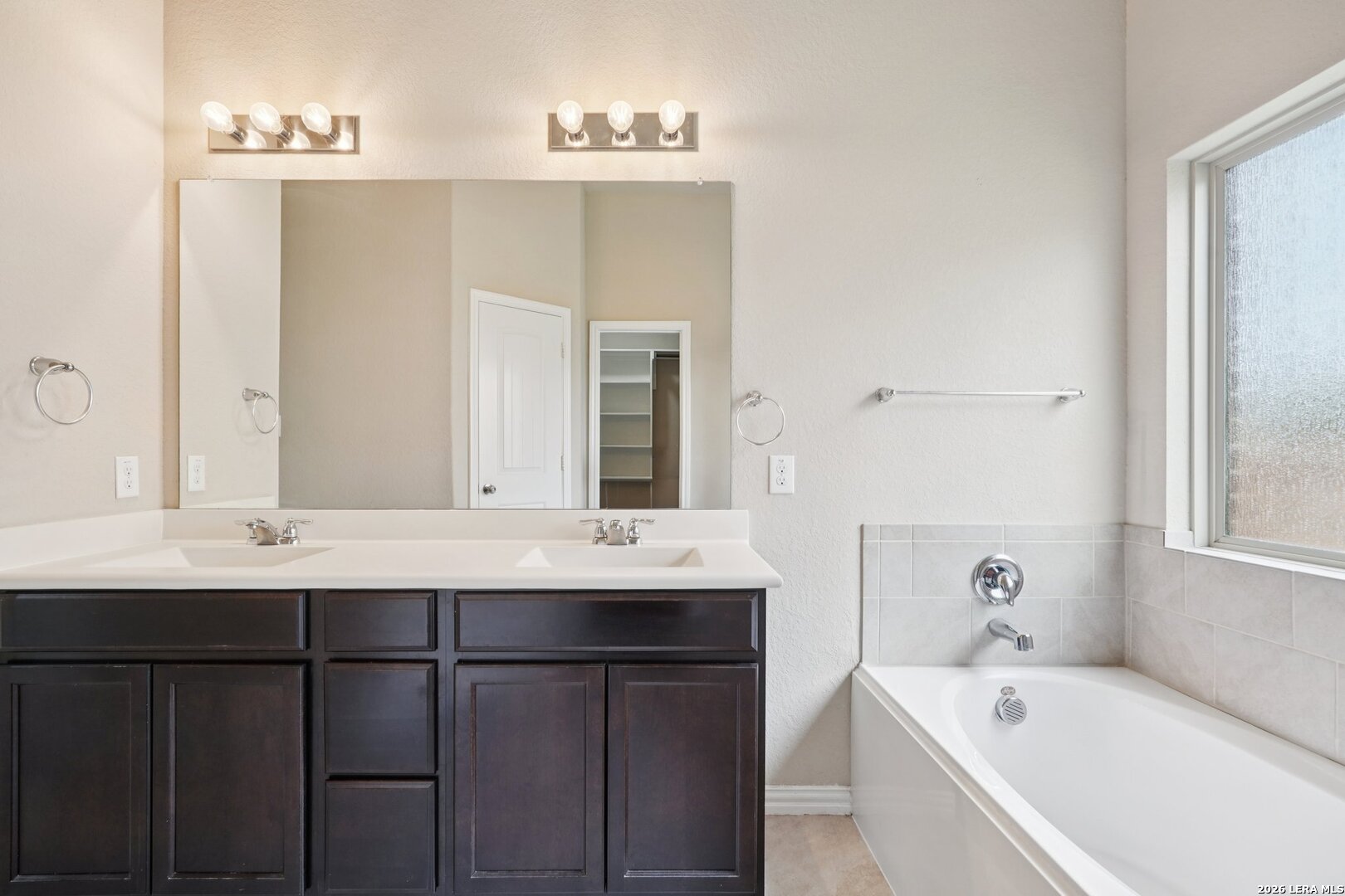 8722 Study Butte San Antonio, TX 78254 - Photo 24 of 40 a bathroom with a double vanity sink and mirror